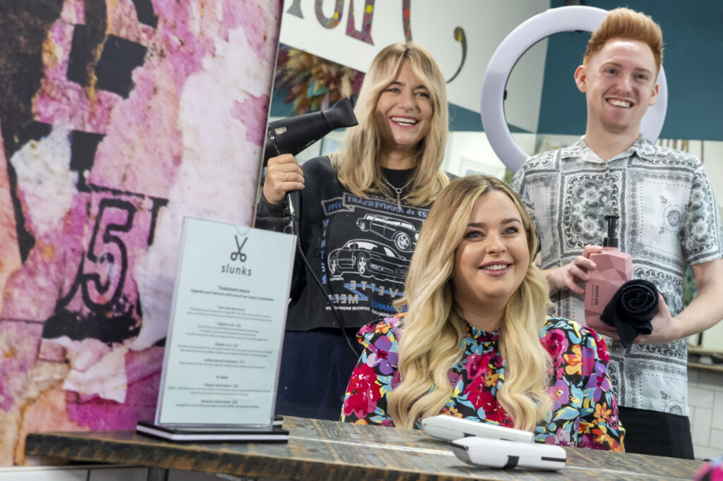 Press shot of 3 hair stylists in Slunks hair salon