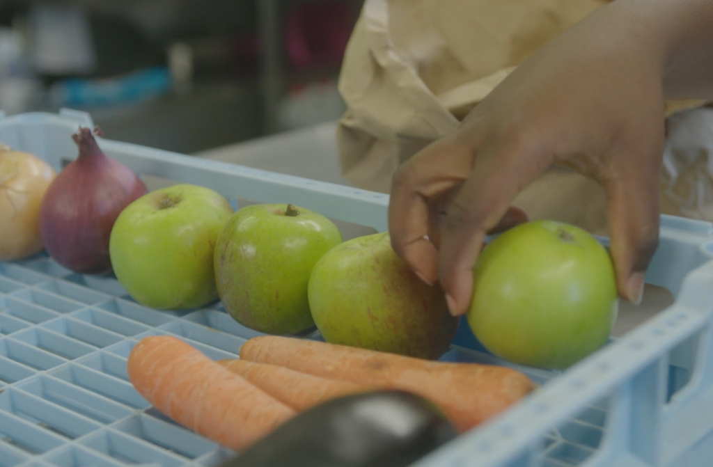 Fruit in a tray being organised by food bank volunteers